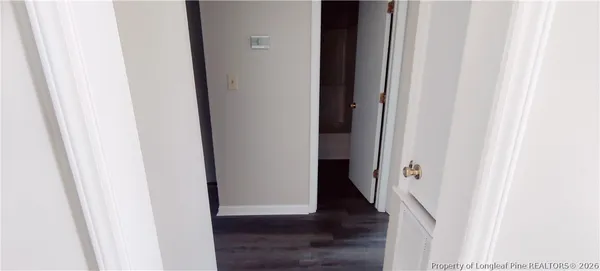 a view of a hallway with wooden floor