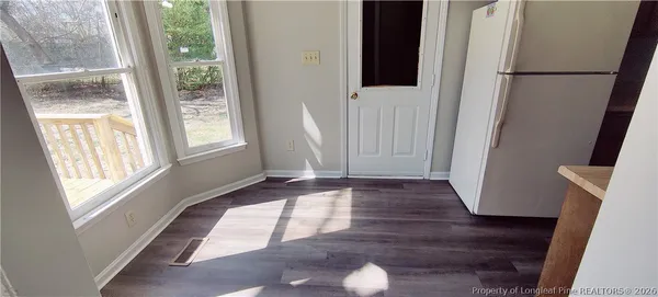 a view of entryway with window and wooden floor