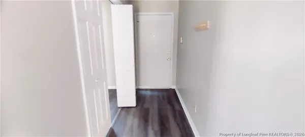 a view of a hallway with wooden floor