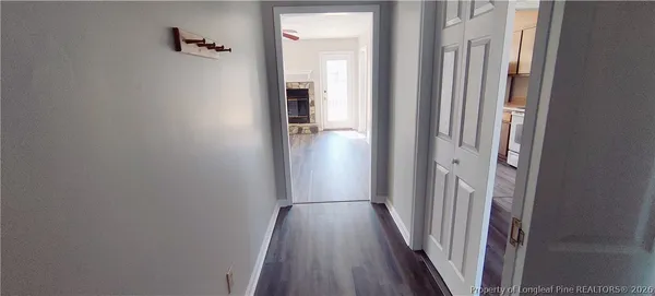 a view of a hallway with wooden floor