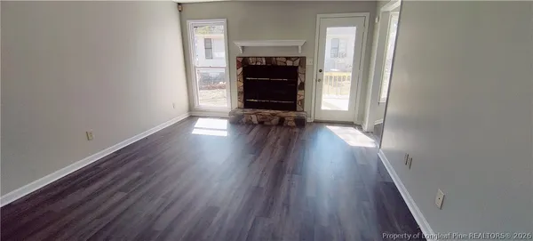 wooden floor in an empty room with a fireplace