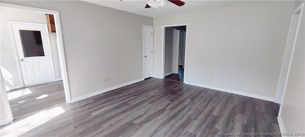 a view of a room with wooden floor and a window