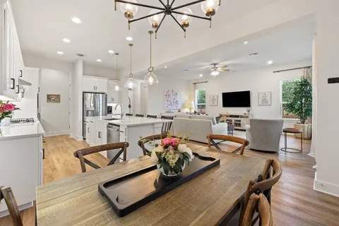 a living room with furniture and kitchen view