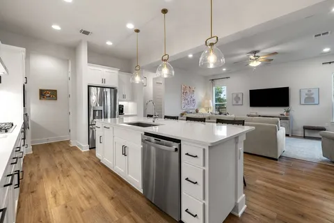 a kitchen with stainless steel appliances kitchen island a large island in the center