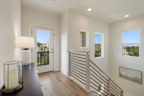 a spacious bedroom with a bed and glass walk in closet
