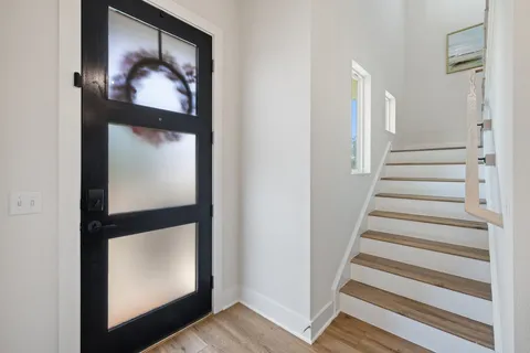 a view of an entryway with wooden floor