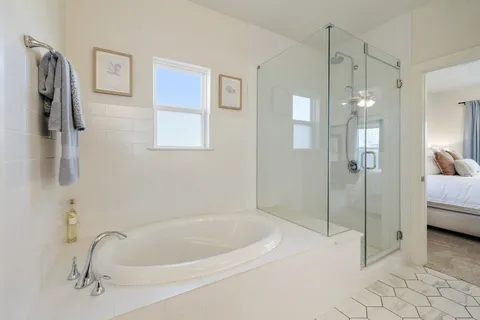 a bedroom with furniture and a large window