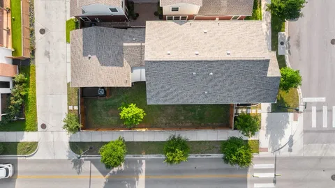 an aerial view of a house with a yard and balcony