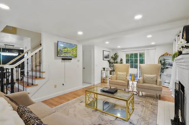 a living room with furniture a rug and a table
