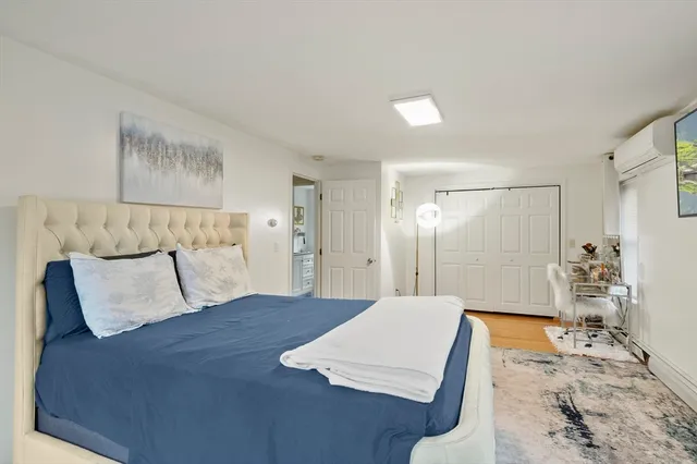 a bedroom with a large bed and a chandelier