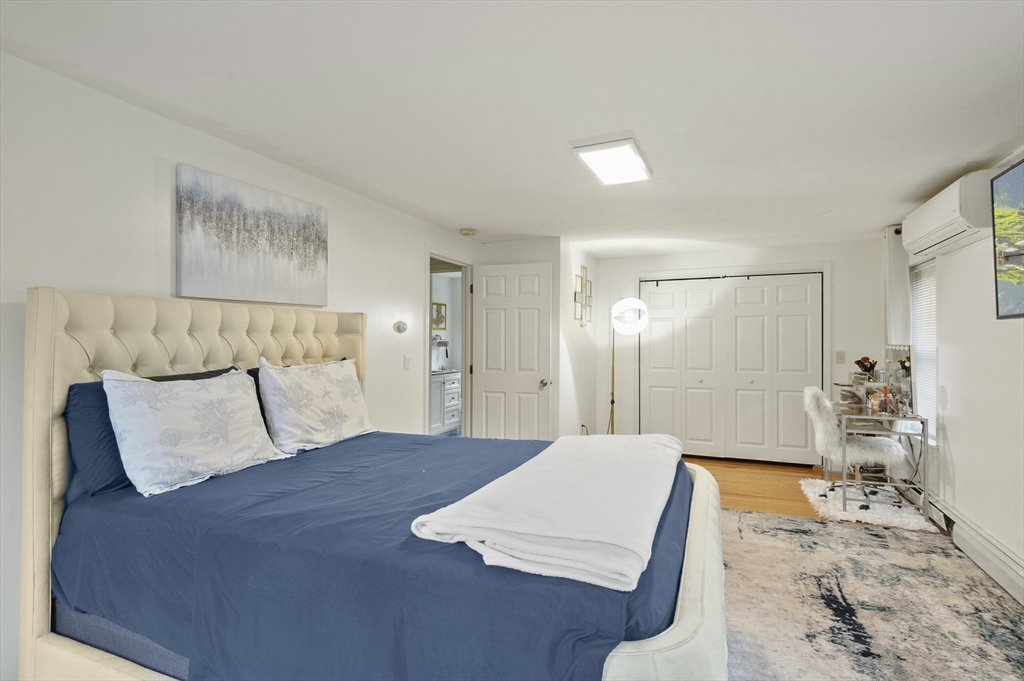 108 Royalston Road North Winchendon, MA 01475 - Photo 20 of 32 a bedroom with a large bed and a chandelier