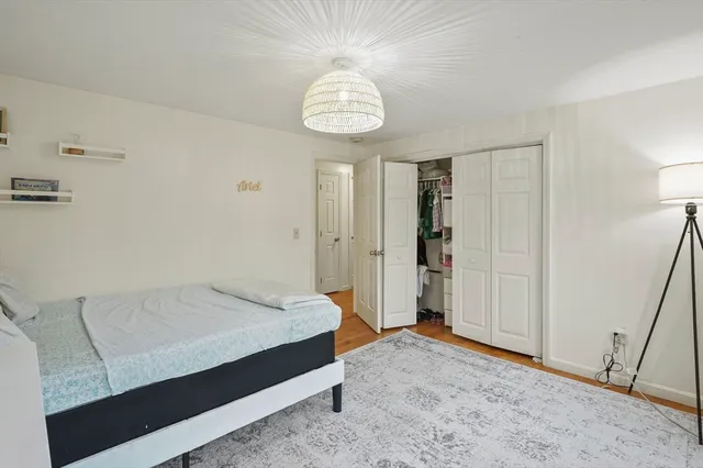 a spacious bedroom with a bed and a chandelier