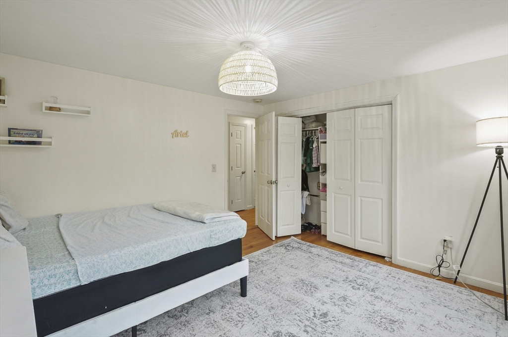 108 Royalston Road North Winchendon, MA 01475 - Photo 22 of 32 a spacious bedroom with a bed and a chandelier