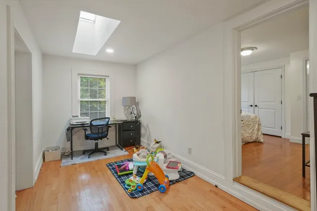 a view of a livingroom with lounge chair and a window