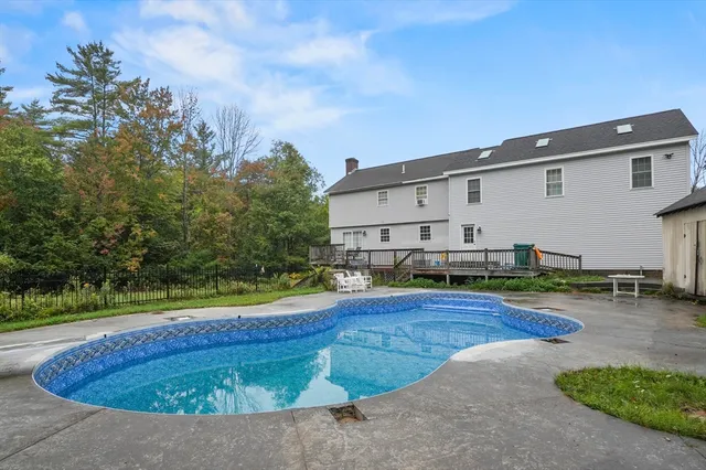 a view of a house with swimming pool and yard