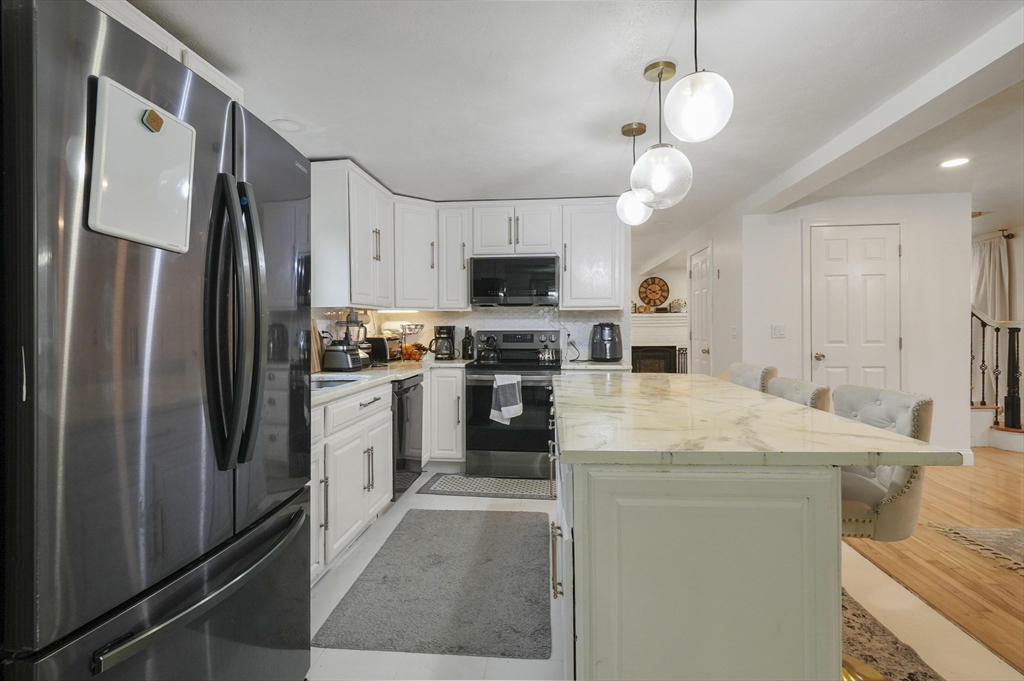 108 Royalston Road North Winchendon, MA 01475 - Photo 7 of 32 a kitchen with a refrigerator a microwave oven a sink and dishwasher