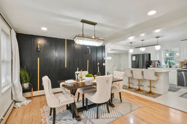 a dining room with furniture and wooden floor