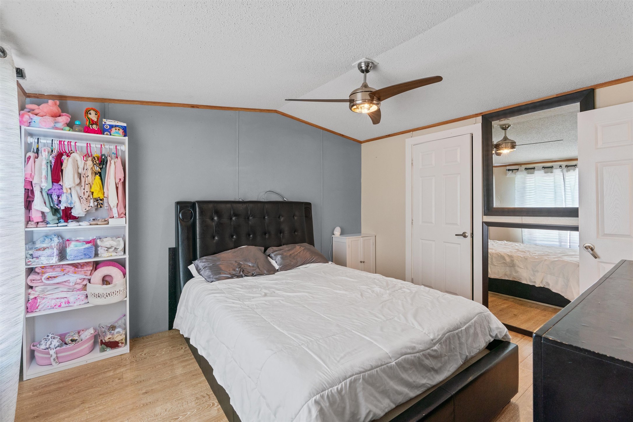 218 Boxcar Path Kyle, TX 78640 - Photo 6 of 21 Well-lit sleeping quarters with a ceiling fan, a spacious closet, and durable wood flooring.