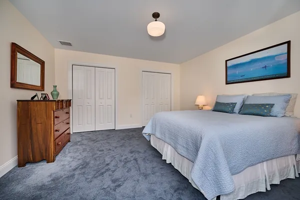 a bedroom with a bed and dresser