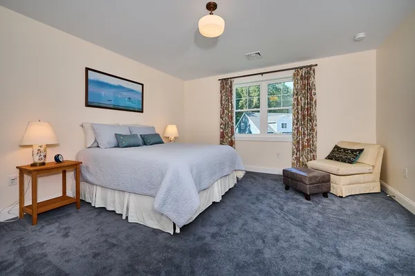 a spacious bedroom with a bed and window