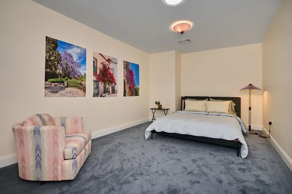 a spacious bedroom with a bed and a couch