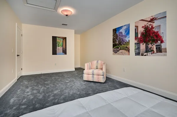 a living room with furniture and wall paintings
