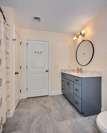 a bathroom with a double vanity sink and a mirror