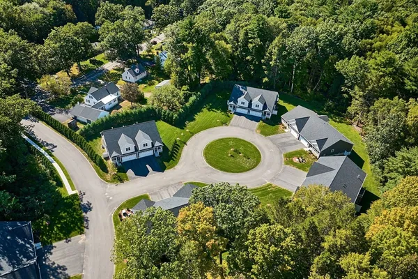 an aerial view of a house with a swimming pool outdoor seating and yard