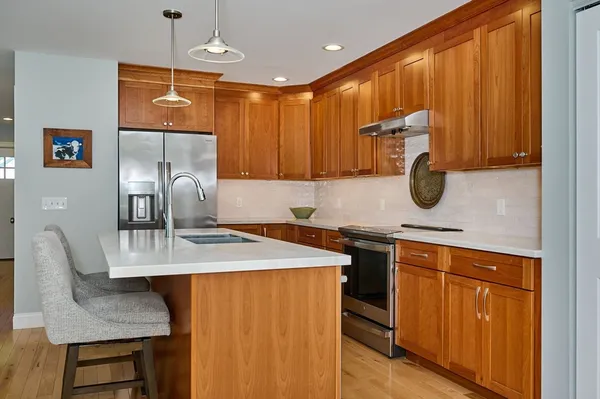 a kitchen with a sink cabinets and wooden floor