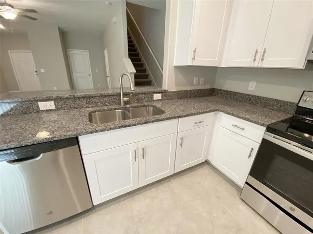 an empty room with a ceiling fan and a window