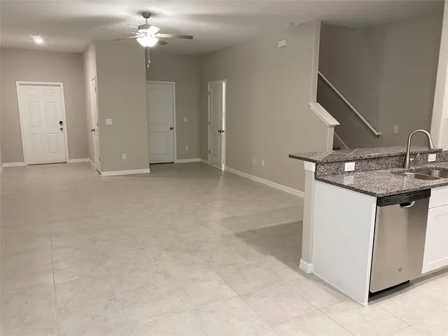 a white toilet sitting next to a shower