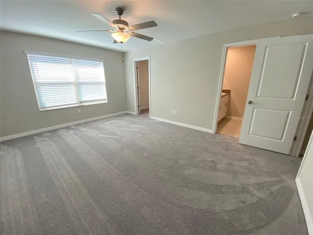 a bathroom with a granite countertop sink a toilet and a shower