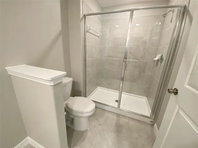 a bathroom with a double vanity sink toilet mirror and shower