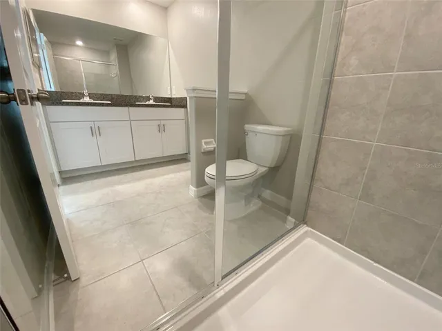 a white toilet sitting next to a bath tub