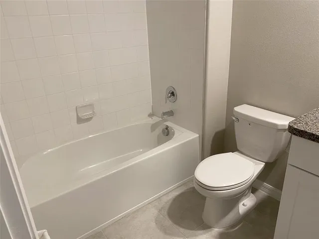 an empty room with a ceiling fan and a window