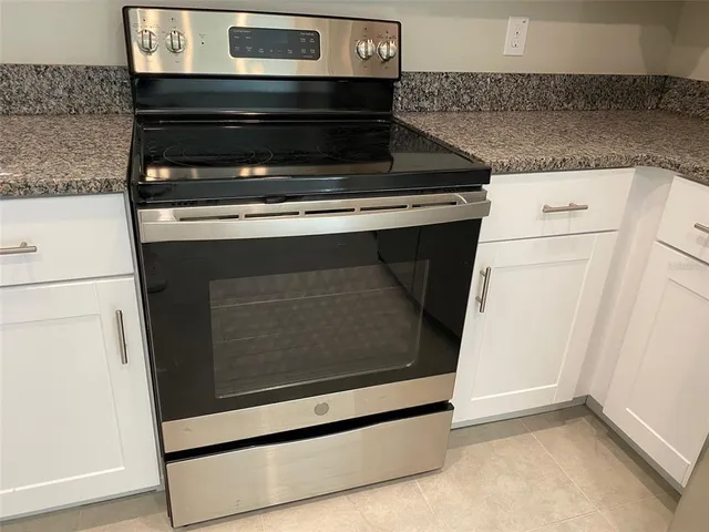 a stove top oven sitting inside of a kitchen