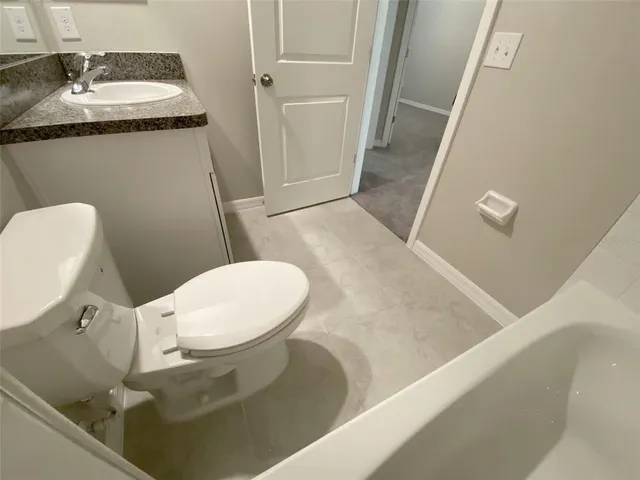 an empty room with kitchen appliances and windows