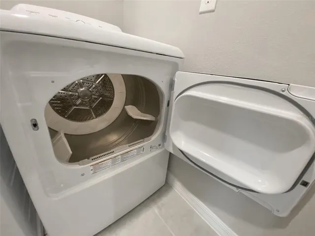 an aerial view of a house with a garden and lake view