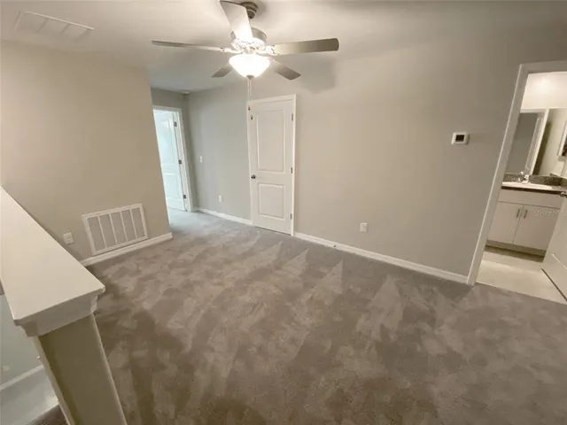 an aerial view of a house with swimming pool and large trees