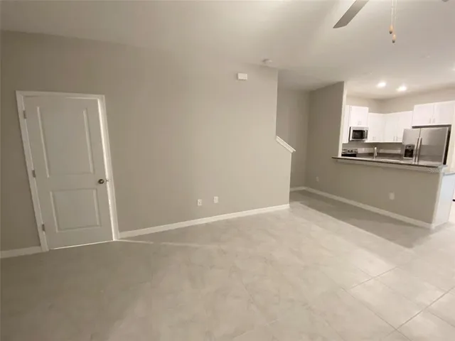 a view of a swimming pool with a patio and a yard