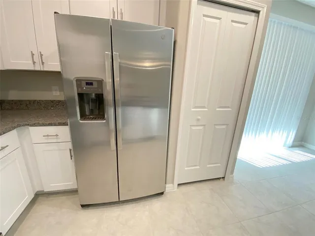 a kitchen with a refrigerator and cabinets