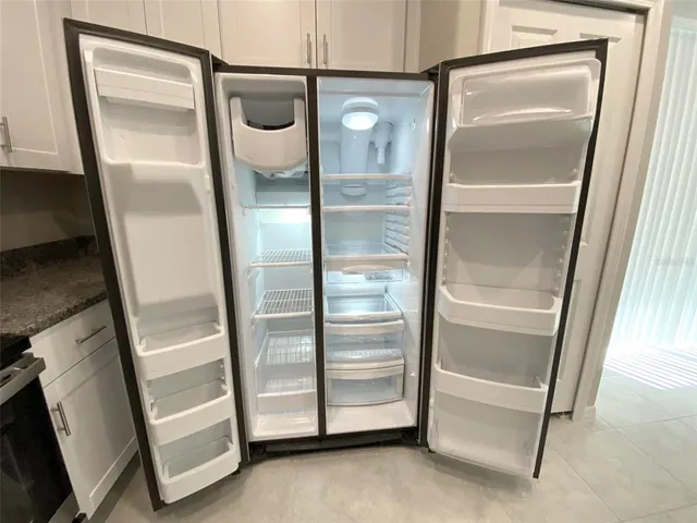 a bathroom with a glass door shower and mirror