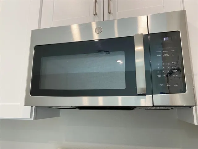 a kitchen with granite countertop white cabinets and a sink