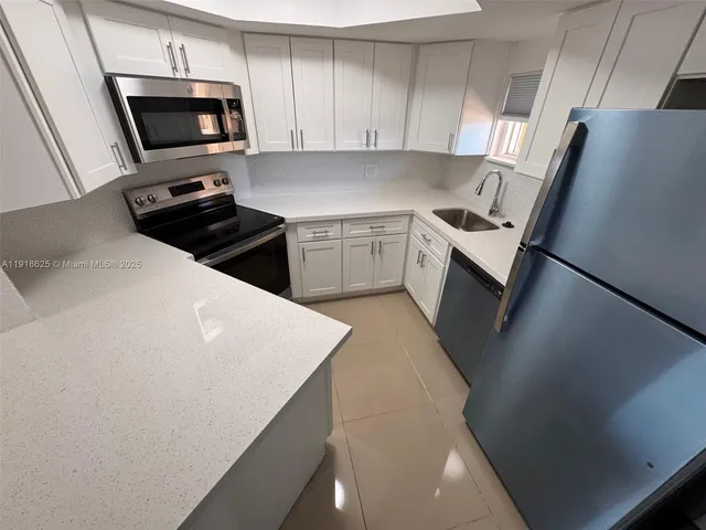 a kitchen with a sink a stove and refrigerator