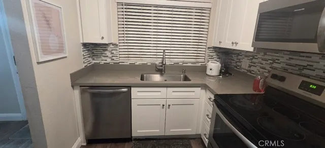 a kitchen with a sink and cabinets