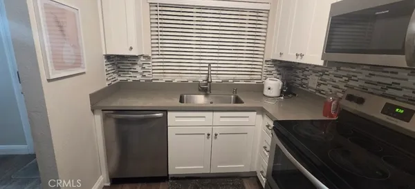 a kitchen with a sink and a stove