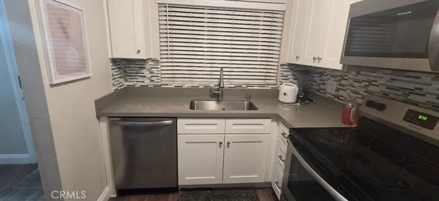 a kitchen with a sink and a stove