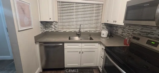 a kitchen with a sink and cabinets