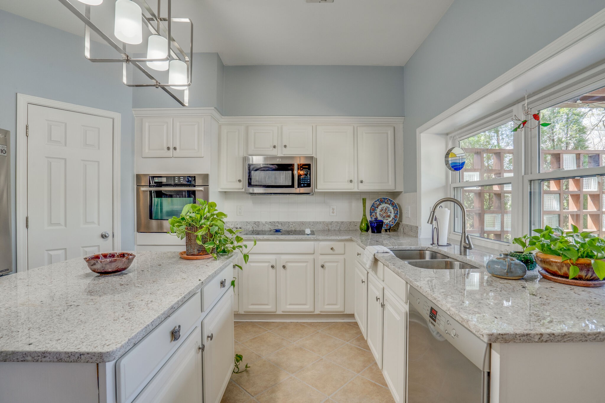 305 Knowle Place Franklin, TN 37069 - Photo 14 of 34 a kitchen with kitchen island white cabinets and white appliances