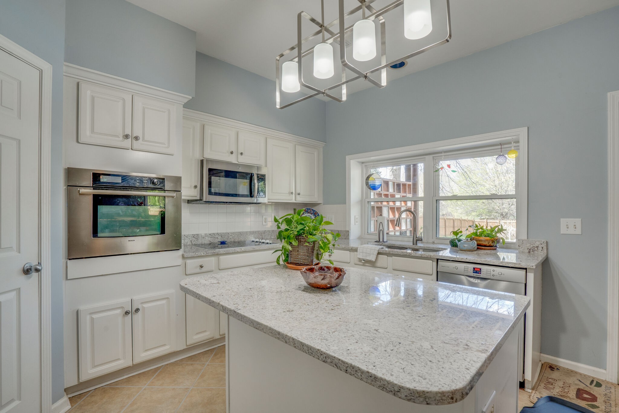 305 Knowle Place Franklin, TN 37069 - Photo 16 of 34 a kitchen with stainless steel appliances granite countertop a sink a stove and microwave